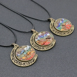 Three bronze crescent moon pendants with colorful natural crystal stone inlay on black cords