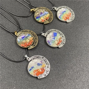 Detail of five crescent moon necklaces with spinning colorful natural crystal stone centers