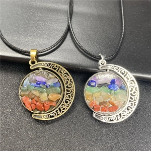 Macro detail of sun and moon chakra necklaces with colorful natural crystals and woven cord