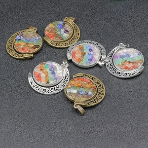 Rotating crescent moon pendant with colorful chakra crystals and hollow retro patterns