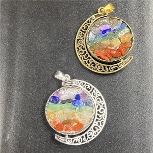 Detailed close-up of crescent moon pendants with colorful natural crystal stone inlay