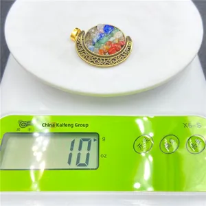 Detail view of the bohemian crescent moon pendant weighing 10 grams on a digital scale