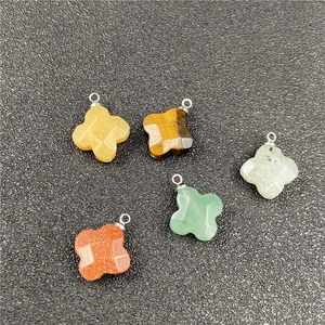 Detail of faceted clover stone pendants in tiger eye, aventurine and goldstone finishes