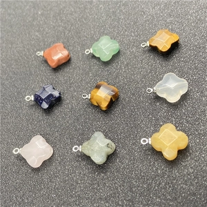 Macro shot of faceted four-leaf clover gemstone pendants with silver metal connectors