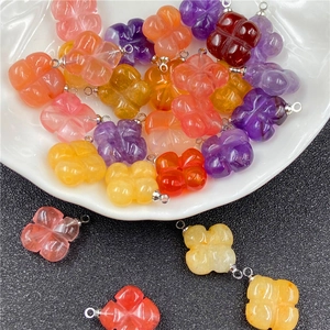 Detailed view of carved amethyst four-leaf clover charms for DIY jewelry making