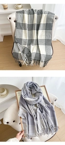 Detail of vintage thick plaid scarves with soft fringes in classic black and beige patterns