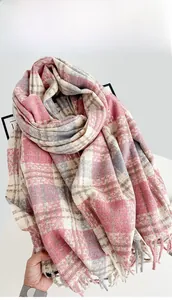 Detail of pink and grey plaid scarf showing soft cashmere-like texture and fringed edges