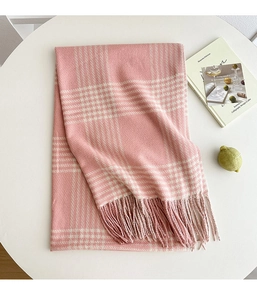 Close-up of pink and white checkered scarf featuring soft cashmere texture and fringe edges