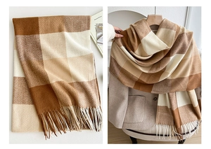 Close-up of retro plaid scarf with soft fringe texture and warm caramel tones