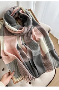 Detail of soft plaid scarf with gray, pink, and cream blocks and fringed tassel ends