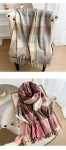 Close-up detail of soft plaid scarf with tassels in brown and pink color blocks