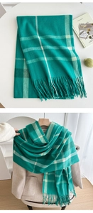 Close-up of green and white plaid scarf featuring soft texture and fine fringe details
