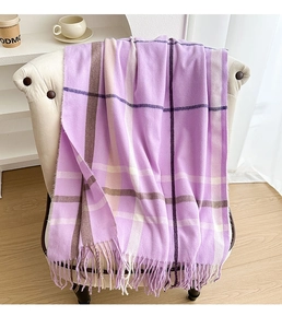 Close-up of purple plaid scarf featuring long fringe detail and soft cashmere texture