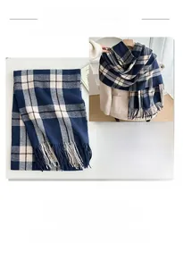 Close-up of thick blue and brown plaid scarf with tassels on a yellow coat