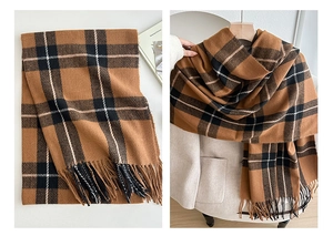 Close-up of caramel plaid scarf with long fringe detail and thick woven texture
