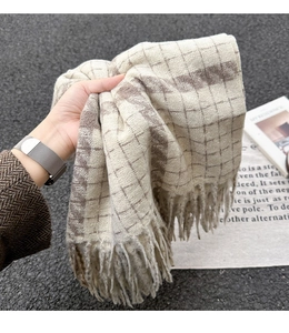 Nahaufnahme des dicken beige-braun karierten Schals mit weicher Kaschmir-Textur und Fransen