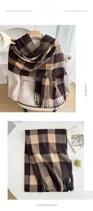 Detail of classic plaid scarf with soft tassels and warm brown beige checkered pattern