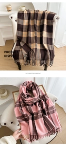 Detail of soft plaid tassels on thick checkered cashmere-feel scarves in warm winter tones