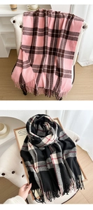 Close-up of thick winter scarves showing classic plaid patterns and soft fringe tassels