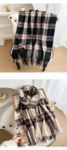 Close-up of thick plaid tassel scarves in classic red and vintage brown patterns
