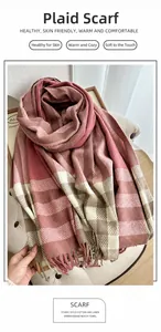 Detail of soft plaid scarf with pink and beige check patterns and long fringe edges