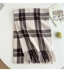 Detail of classic plaid scarf with soft fringes and beige windowpane pattern design