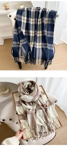 Detail of classic plaid scarves with long tassels and soft thick knit texture