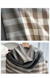 Macro shot of thick brown plaid scarf texture showing soft twill weave and fiber detail