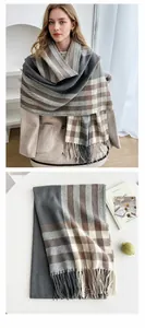 Detailed view of thick plaid tassel shawl with grey and beige cashmere-like texture