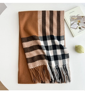 Close-up of caramel and cream plaid scarf featuring thick fringe and cozy wool texture