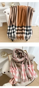 Detail of soft plaid scarves with fringe edges in classic brown and pink checkered patterns