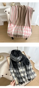Detail of soft plaid scarves with fringe edges in pink, grey and black color combinations