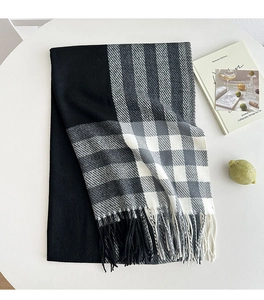 Detail of classic black and white plaid scarf with soft fringe texture for autumn winter