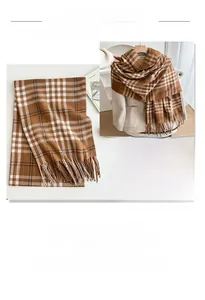 Detail of brown plaid scarf showing thick cashmere-like texture and tassel design