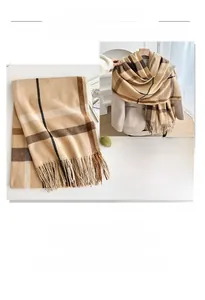 Detail of thick cashmere-feel plaid scarf with classic tassels and soft fringes