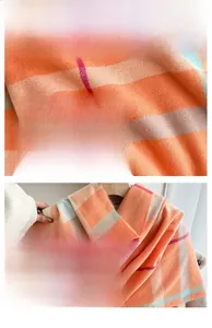 Close-up of thick orange plaid scarf showing soft twill weave texture and fine fringe