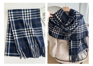 Detailed view of the navy plaid scarf's soft texture and elegant long fringe design