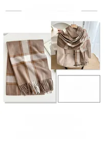 Detail of plaid scarf texture with soft tassels and earthy brown checkered pattern