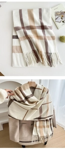 Detail of soft beige and brown plaid cashmere scarf with delicate fringe tassels