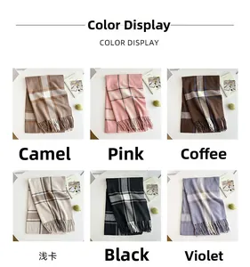 Close-up of multiple color options for thick plaid tassels scarves on a white table