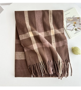 Close-up of soft plaid scarf with fringe detail and luxury cashmere-like texture