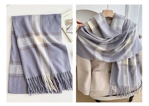 Detail of plaid scarf featuring lavender and brown checks with soft tassel edges