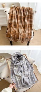 Detail of plaid scarves with fringe ends in camel and grey-blue soft thick fabric