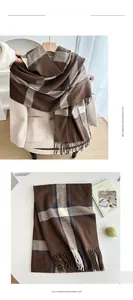 Macro detail of thick plaid scarf texture with soft fringe and brown check pattern