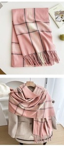 Close-up of pink checkered scarf with soft cashmere-feel texture and fine tassel edges