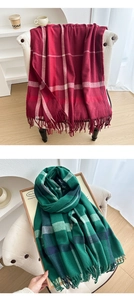 Detail of red and green plaid scarves with soft fringe textures for winter warmth