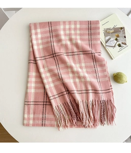 Detail of pink and white plaid scarf featuring soft cashmere texture and fringe tassel