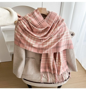 Detail of pink plaid scarf with soft fringe tassels and thick cashmere-like texture