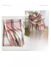 Close-up of pink and grey plaid scarf with thick fringe detail for winter warmth