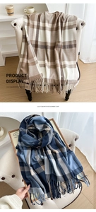 Close-up of contrast color plaid scarf with thick fringe detail and soft cashmere texture